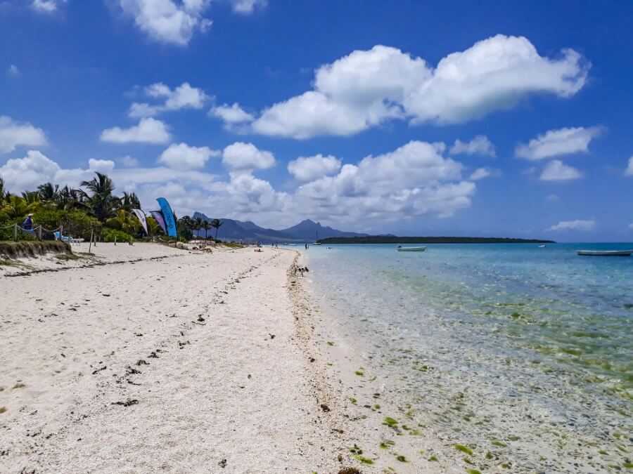 a white sand beach with mountain view at pointe d'esny - one week in mauritius