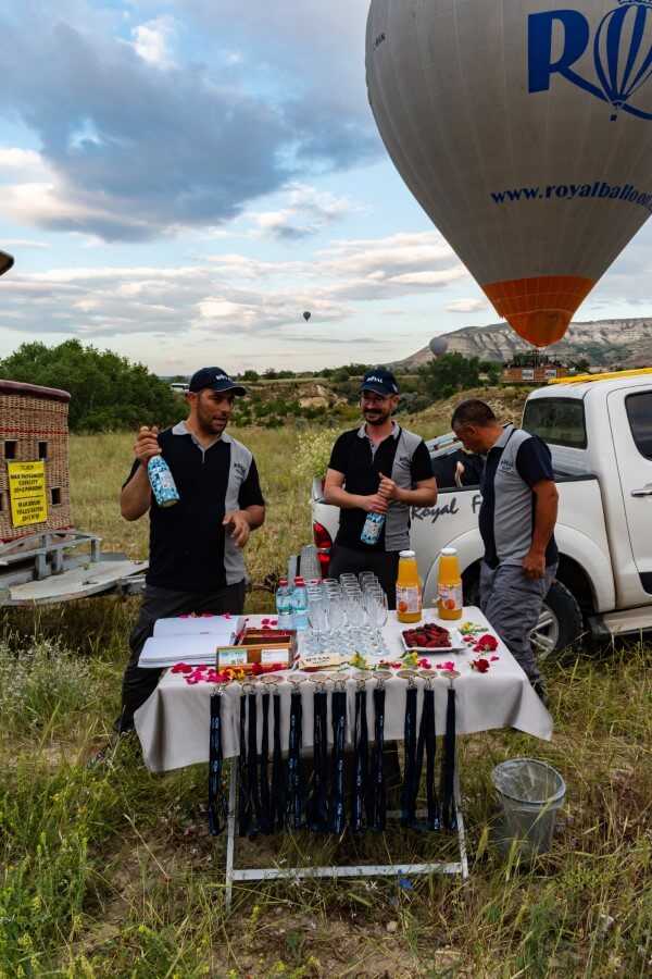 royal balloon pilots popping champagne after hot air balloon flight