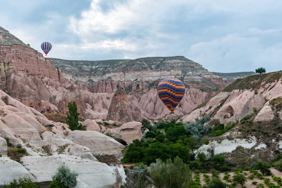 two hot air balloons floating over Rose valley in Cappadocia