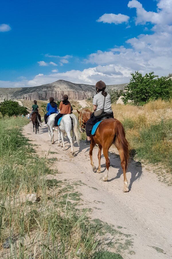 four women riding horses in Cappadocia