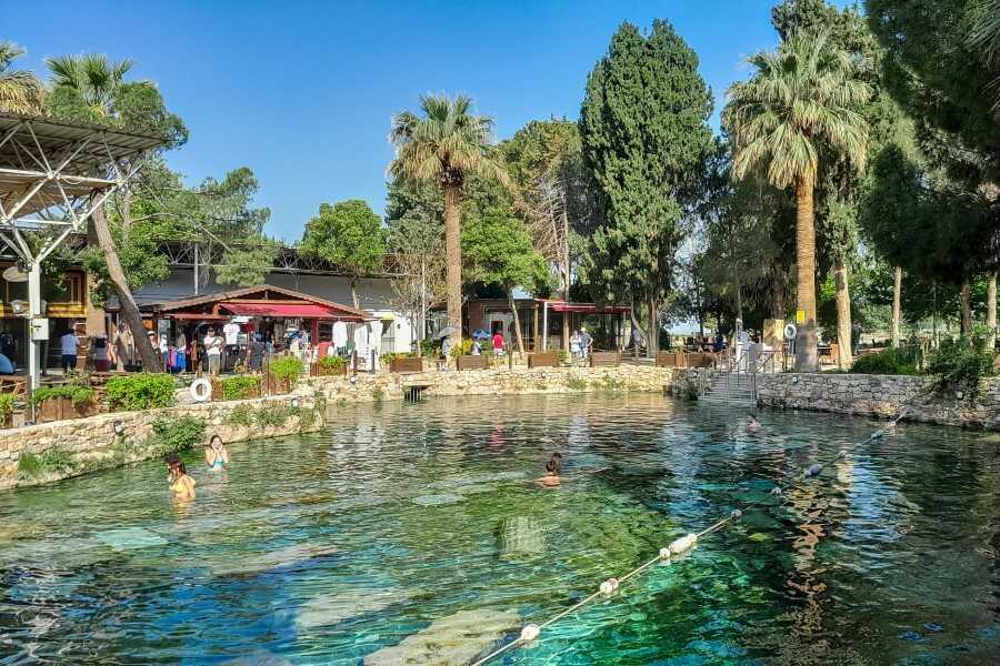 people swimming in the cleopatra pool in pamukkale