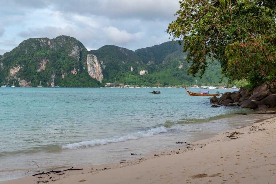 a white sand beach overlooking a mountain at viking beach