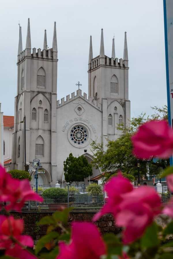 Church of St Francis Xavier in malacca surrounded by flowers