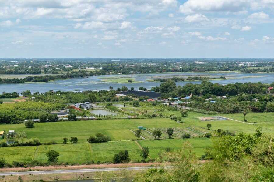 View of rice paddies and river from Tham Kaew Kanchanaphisek temple kanchanaburi thailand