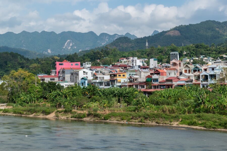 colorful houses along the edge of a river in cao bang city vietnam
