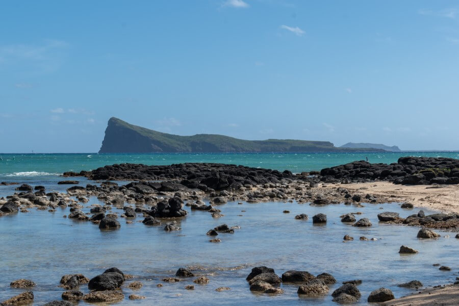 view of an island from a rocky beach at bain boeuf