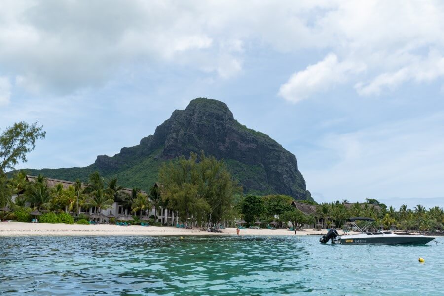view of a mountain from a boat at le morne