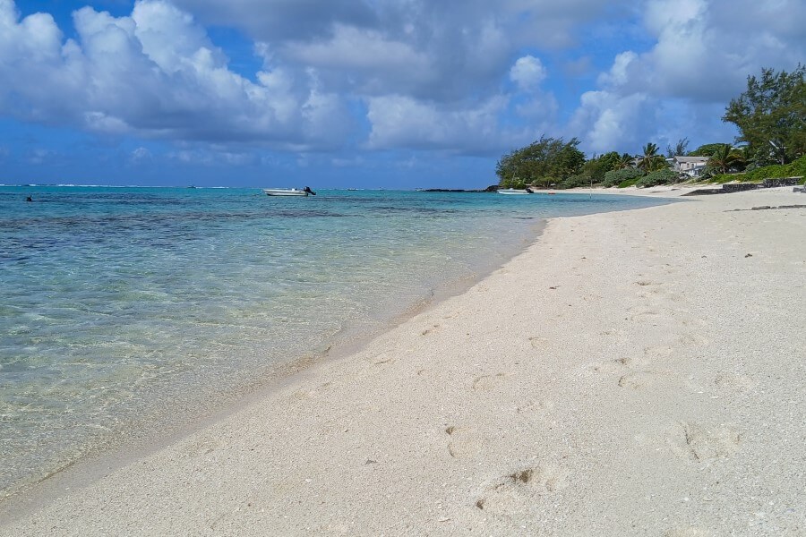 a white sand beach with turquoise water at pointe d'esny